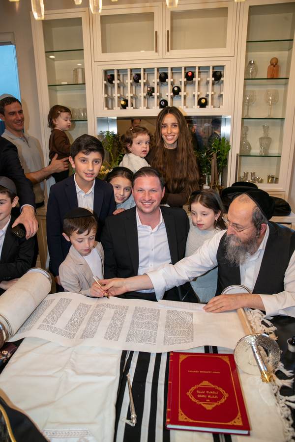 Gathered around the open Sefer Torah