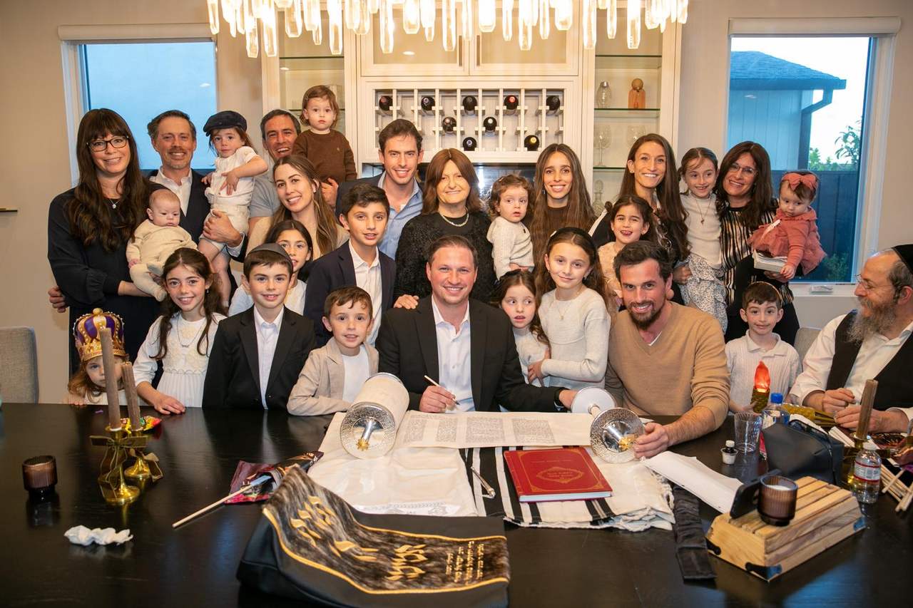 Members and friends of the minyan gathered around the new Sefer Torah